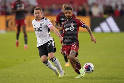 May 27, 2023; Toronto, Ontario, CAN; Toronto FC forward Lorenzo Insigne (24) fights for the ball against D.C. United midfielder Russell Canouse (6) during the first half at BMO Field. Mandatory Credit: Nick Turchiaro-USA TODAY Sports
