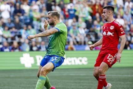 May 27, 2023; Seattle, Washington, USA; Seattle Sounders FC forward Jordan Morris (13) scores a goal against New York Red Bulls defender Dylan Nealis (12) during the first half at Lumen Field. Mandatory Credit: Joe Nicholson-USA TODAY Sports