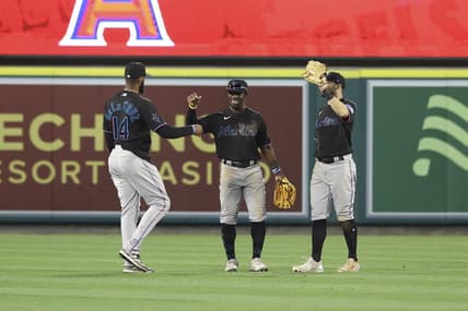 May 27, 2023; Anaheim, California, USA; Miami Marlins left fielder Bryan De La Cruz (14) and Miami Marlins center fielder Jonathan Davis (49) embrace after defeating the Los Angeles Angels 8-5 at Angel Stadium. Mandatory Credit: Jessica Alcheh-USA TODAY Sports