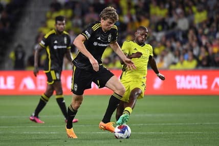May 28, 2023; Nashville, Tennessee, USA; Nashville SC midfielder Fafa Picault (7) fights for the ball against the Columbus Crew defender Philip Quinton (2) during the first half at Geodis Park. Mandatory Credit: Christopher Hanewinckel-USA TODAY Sports