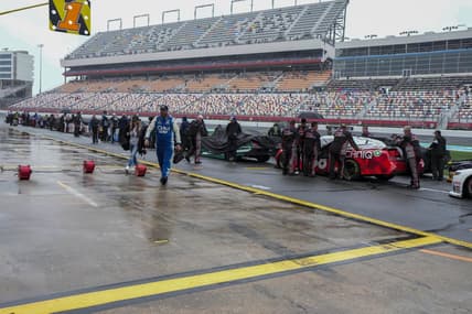 May 29, 2023; Concord, North Carolina, USA; Cars are pushed back to the garage area after NASCAR cancels the Alsco Uniforms 300 at Charlotte Motor Speedway. Mandatory Credit: Jim Dedmon-USA TODAY Sports