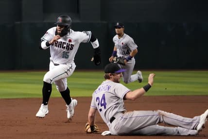 May 29, 2023; Phoenix, Arizona, USA; Arizona Diamondbacks third baseman Emmanuel Rivera (15) runs by Colorado Rockies third baseman Ryan McMahon (24)  en route to scoring a run during the second inning at Chase Field. Mandatory Credit: Joe Camporeale-USA TODAY Sports