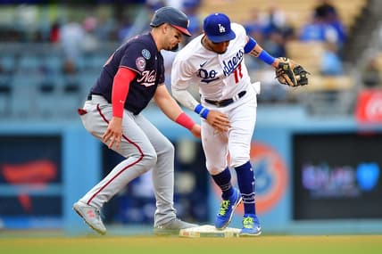 May 31, 2023; Los Angeles, California, USA; Washington Nationals designated hitter Joey Meneses (45) gets back to second against Los Angeles Dodgers shortstop Miguel Rojas (11) during the fifth inning at Dodger Stadium. Mandatory Credit: Gary A. Vasquez-USA TODAY Sports
