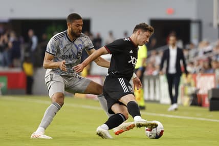 May 31, 2023; Washington, District of Columbia, USA; D.C. United midfielder Theodore Ku-DiPietro (21) dribbles the ball as CF Montr al defender George Campbell (24) defends in the first half at Audi Field. Mandatory Credit: Geoff Burke-USA TODAY Sports