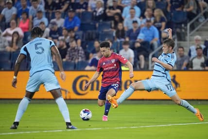 May 31, 2023; Kansas City, Kansas, USA; Sporting Kansas City midfielder Jake Davis (17) goes in for a tackle against FC Dallas forward Alan Velasco (20) during the first half at Children's Mercy Park. Mandatory Credit: Jay Biggerstaff-USA TODAY Sports