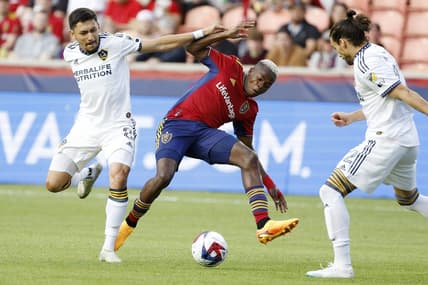 May 31, 2023; Sandy, Utah, USA; Los Angeles Galaxy midfielder Marco Delgado (8) and Real Salt Lake forward Carlos Andres Gomez (11) battle in the first half at America First Field. Mandatory Credit: Jeff Swinger-USA TODAY Sports