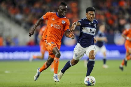 Jul 13, 2022; Cincinnati, Ohio, USA; FC Cincinnati midfielder Obinna Nwobodo (5) battles for the ball against Vancouver Whitecaps midfielder Michael Baldisimo (33) in the second half at TQL Stadium. Mandatory Credit: Katie Stratman-USA TODAY Sports