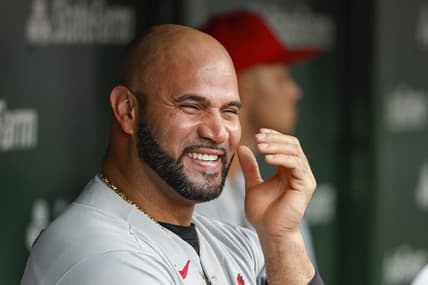 Aug 25, 2022; Chicago, Illinois, USA; St. Louis Cardinals designated hitter Albert Pujols (5) smiles in the dugout during the ninth inning against the Chicago Cubs at Wrigley Field. Mandatory Credit: Kamil Krzaczynski-USA TODAY Sports