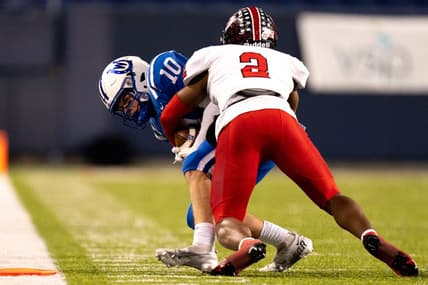 Cleveland Glenville defensive back Bryce West (2) tackles Wyoming Cowboys wide receiver Will Svendsen (10) causing a turnover on downs in the third quarter of the OHSAA DIV state championship game between at Tom Benson Hall of Fame Stadium in Canton, Ohio, on Saturday, Dec. 3, 2022.

High School Football Wyoming Vs Cleveland Glenville In Ohsaa Div State Championship Game
