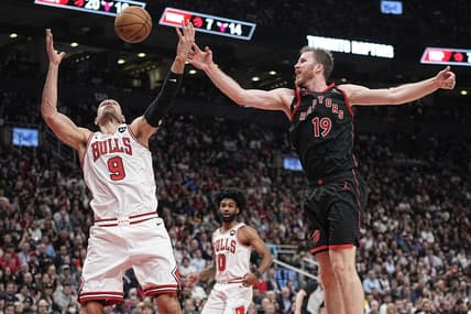 Apr 12, 2023; Toronto, Ontario, CAN; Chicago Bulls center Nikola Vucevic (9) and Toronto Raptors center Jakob Poeltl (19) battle for a rebound during the second half of a NBA Play-In game at Scotiabank Arena. Mandatory Credit: John E. Sokolowski-USA TODAY Sports