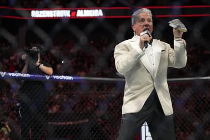 May 13, 2023; Charlotte, North Carolina, USA; Ring announcer Bruce Buffer introduces the fighters before a a heavyweight bout between Jairzinho Rozenstruik (red gloves) and Jailton Almeida  (blue gloves) during UFC Fight Night at Spectrum Center. Mandatory Credit: Jim Dedmon-USA TODAY Sports
