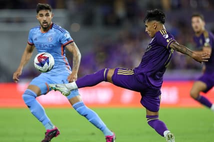 May 17, 2023; Orlando, Florida, USA;  Orlando City SC forward Facundo Torres (17) clears at the ball from New York City FC defender Thiago Martins (13) in the first half at Exploria Stadium. Mandatory Credit: Nathan Ray Seebeck-USA TODAY Sports