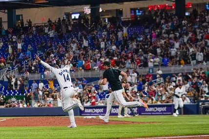 May 31, 2023; Miami, Florida, USA; Miami Marlins left fielder Bryan De La Cruz (14) runs onto the field after defeating the San Diego Padres at loanDepot Park. Mandatory Credit: Rich Storry-USA TODAY Sports