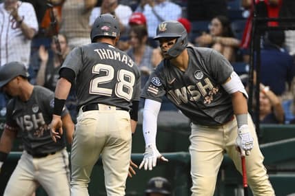 Jun 2, 2023; Washington, District of Columbia, USA; Washington Nationals right fielder Lane Thomas (28) is congratulated by designated hitter Joey Meneses (45) after scoring against the Philadelphia Phillies during the first inning at Nationals Park. Mandatory Credit: Brad Mills-USA TODAY Sports