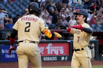 Jun 2, 2023; Phoenix, Arizona, USA; Arizona Diamondbacks shortstop Geraldo Perdomo (2) and Arizona Diamondbacks center fielder Corbin Carroll (7) celebrate after scoring runs against the Atlanta Braves during the first inning at Chase Field. Mandatory Credit: Joe Camporeale-USA TODAY Sports