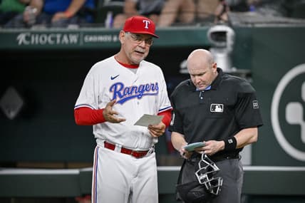 Jun 3, 2023; Arlington, Texas, USA; Texas Rangers manager Bruce Bochy (15) talks with home plate umpire Mike Estabrook during the game against the Seattle Mariners at Globe Life Field. Mandatory Credit: Jerome Miron-USA TODAY Sports