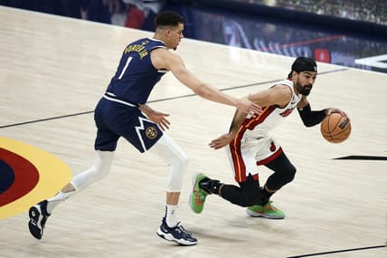 Jun 4, 2023; Denver, CO, USA; Miami Heat guard Gabe Vincent (2) controls the ball against Denver Nuggets forward Michael Porter Jr. (1) in the first half in game two of the 2023 NBA Finals at Ball Arena. Mandatory Credit: Isaiah J. Downing-USA TODAY Sports