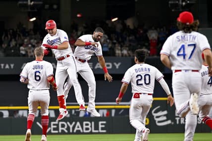 Jun 5, 2023; Arlington, Texas, USA; The Texas Rangers run on to the field after first baseman Nathaniel Lowe (30) drives in the game winning run against the St. Louis Cardinals during the ninth inning at Globe Life Field. Mandatory Credit: Jerome Miron-USA TODAY Sports