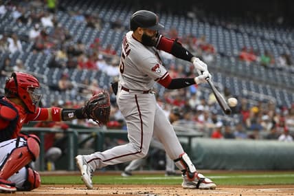 Jun 6, 2023; Washington, District of Columbia, USA; Arizona Diamondbacks designated hitter Emmanuel Rivera (15) hits a RBI single against the Washington Nationals during the first inning at Nationals Park. Mandatory Credit: Brad Mills-USA TODAY Sports