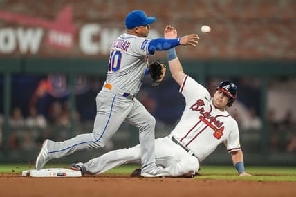 Jun 6, 2023; Cumberland, Georgia, USA; New York Mets third baseman Eduardo Escobar (10) throws for a double play over Atlanta Braves third baseman Austin Riley (27) during the first inning at Truist Park. Mandatory Credit: Dale Zanine-USA TODAY Sports