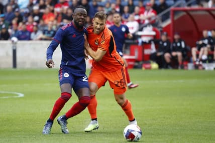 Jun 6, 2023; Bridgeview, IL, USA; Chicago Fire forward Kei Kamara (23) kicks the ball past Houston Dynamo defender Erik Sviatchenko (28) during the first half at SeatGeek Stadium. Mandatory Credit: Mike Dinovo-USA TODAY Sports