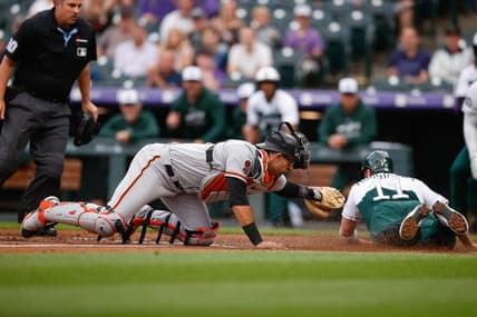 Jun 7, 2023; Denver, Colorado, USA; Colorado Rockies first baseman Mike Moustakas (11) slides safely home ahead of the tag from San Francisco Giants catcher Blake Sabol (2) in the second inning at Coors Field. Mandatory Credit: Isaiah J. Downing-USA TODAY Sports