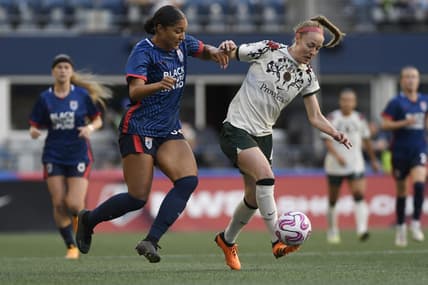 Jun 3, 2023; Seattle, Washington, USA; OL Reign forward Elyse Bennett (34) and Portland Thorns FC defender Becky Sauerbrunn (4) battle for the ball during the second half at Lumen Field. Mandatory Credit: Michael Thomas Shroyer-USA TODAY Sports