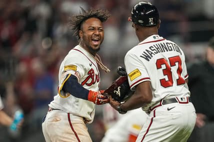 Jun 8, 2023; Cumberland, Georgia, USA; Atlanta Braves second baseman Ozzie Albies (1) reacts by handing his helmet to third base coach Ron Washington (37) after hitting a walk off three run home run against the New York Mets during the tenth inning at Truist Park. Mandatory Credit: Dale Zanine-USA TODAY Sports