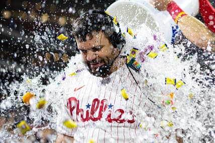 Jun 9, 2023; Philadelphia, Pennsylvania, USA; Philadelphia Phillies left fielder Kyle Schwarber (12) is doused by a cooler of water and bubble gum after hitting a walk off game winning home run against the Los Angeles Dodgers during the ninth inning at Citizens Bank Park. Mandatory Credit: Bill Streicher-USA TODAY Sports