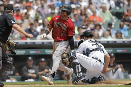 Jun 10, 2023; Detroit, Michigan, USA;  Arizona Diamondbacks catcher Gabriel Moreno (14) is tagged out by Detroit Tigers catcher Jake Rogers (34) in the second inning at Comerica Park. Mandatory Credit: Rick Osentoski-USA TODAY Sports