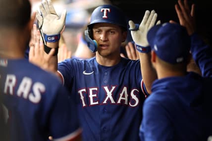 Jun 10, 2023; St. Petersburg, Florida, USA;  Texas Rangers shortstop Corey Seager (5) is congratulated in the dugout after hitting a 2-run home run against the Tampa Bay Rays during the fourth inning at Tropicana Field. Mandatory Credit: Kim Klement-USA TODAY Sports