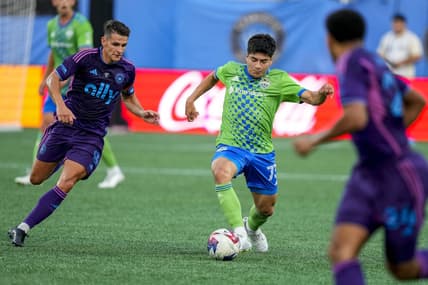 Jun 10, 2023; Charlotte, North Carolina, USA; Seattle Sounders forward Jordan Morris (13) tries to dribble past Charlotte FC midfielder Ashley Westwood (8) during the first half at Bank of America Stadium. Mandatory Credit: Jim Dedmon-USA TODAY Sports