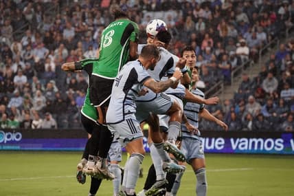 Jun 10, 2023; Kansas City, Kansas, USA; Austin FC defender Julio Cascante (18) heads the ball against Sporting Kansas City defender Robert Castellanos (19) during the first half at Children's Mercy Park. Mandatory Credit: Denny Medley-USA TODAY Sports