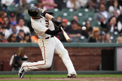 Jun 10, 2023; San Francisco, California, USA; San Francisco Giants left fielder Mitch Haniger (17) hits a double against the Chicago Cubs during the eighth inning at Oracle Park. Mandatory Credit: Darren Yamashita-USA TODAY Sports
