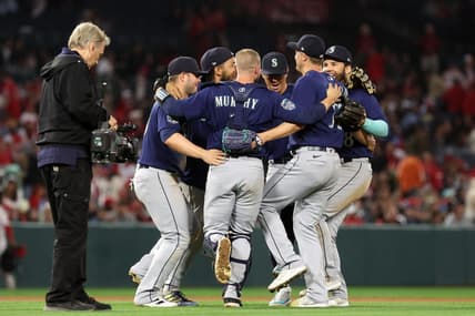 Jun 10, 2023; Anaheim, California, USA;  Seattle Mariners infielders celebrate a victory against the Los Angeles Angels after defeating the Angels 6-2 at Angel Stadium. Mandatory Credit: Kiyoshi Mio-USA TODAY Sports