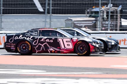Jun 11, 2023; Sonoma, California, USA;  NASCAR Cup Series driver AJ Allmendinger (16) races against NASCAR Cup Series driver Ty Gibbs (54) at Sonoma Raceway. Mandatory Credit: Stan Szeto-USA TODAY Sports