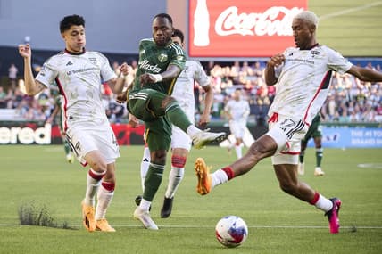 Jun 11, 2023; Portland, Oregon, USA;  Portland Timbers forward Franck Boli (7) takes a shot on goal during the first half against FC Dallas defender Marco Farfan (4) and defender Nkosi Tafari (17) at Providence Park. Mandatory Credit: Troy Wayrynen-USA TODAY Sports