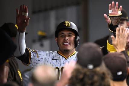 Jun 13, 2023; San Diego, California, USA; San Diego Padres third baseman Manny Machado (right) is congratulated in the dugout after scoring a run against the Cleveland Guardians during the fifth inning at Petco Park. Mandatory Credit: Orlando Ramirez-USA TODAY Sports