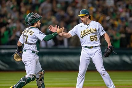 Jun 13, 2023; Oakland, California, USA; Oakland Athletics relief pitcher Trevor May (65) and catcher Shea Langeliers (23) celebrate after the game against the Tampa Bay Rays at Oakland-Alameda County Coliseum. Mandatory Credit: Neville E. Guard-USA TODAY Sports
