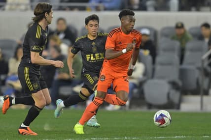 Jun 14, 2023; Los Angeles, California, USA; Houston Dynamo forward Nelson Quinones (21) dribbles the ball ahead against Los Angeles FC defender Erik Duenas (18) during the first half at BMO Stadium. Mandatory Credit: Jayne Kamin-Oncea-USA TODAY Sports