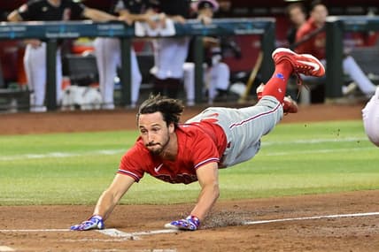Jun 15, 2023; Phoenix, Arizona, USA;  Philadelphia Phillies catcher Garrett Stubbs (21) slides and scores in the fourth inning against the Arizona Diamondbacks at Chase Field. Mandatory Credit: Matt Kartozian-USA TODAY Sports