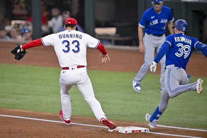 Jun 17, 2023; Arlington, Texas, USA; Texas Rangers starting pitcher Dane Dunning (33) puts out Toronto Blue Jays center fielder Kevin Kiermaier (39) at first base during the third inning at Globe Life Field. Mandatory Credit: Jerome Miron-USA TODAY Sports