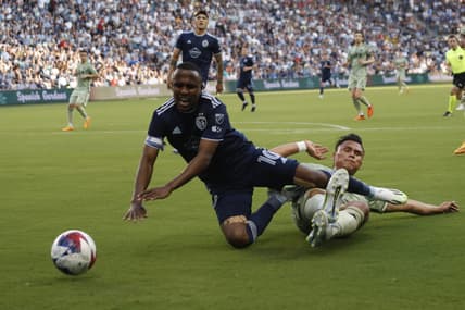 Jun 17, 2023; Kansas City, Kansas, USA; Sporting Kansas City midfielder Gadi Kinda (10) fights for the ball against Los Angeles FC During first half at Children's Mercy Park. Mandatory Credit: Kylie Graham-USA TODAY Sports