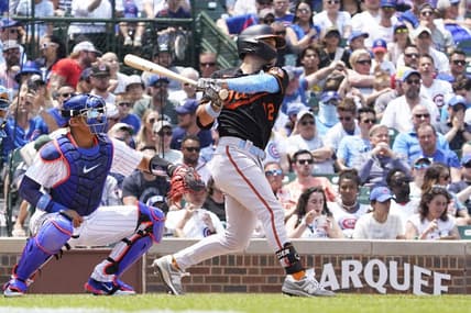 Jun 18, 2023; Chicago, Illinois, USA; Baltimore Orioles second baseman Adam Frazier (12) hits an RBI single against the Chicago Cubs during the sixth inning at Wrigley Field. Mandatory Credit: David Banks-USA TODAY Sports