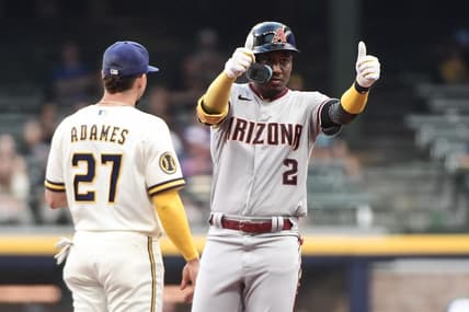 Jun 19, 2023; Milwaukee, Wisconsin, USA; Arizona Diamondbacks shortstop Geraldo Perdomo (2) reacts after hitting a double in the first inning as Milwaukee Brewers shortstop Willy Adames (27) looks on at American Family Field. Mandatory Credit: Benny Sieu-USA TODAY Sports