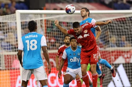 Jun 21, 2023; Harrison, New Jersey, USA; New York Red Bulls defender Sean Nealis (15) battles for header against Charlotte FC midfielder Brandt Bronico (13) during the first half at Red Bull Arena. Mandatory Credit: Vincent Carchietta-USA TODAY Sports