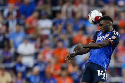 Jun 21, 2023; Cincinnati, Ohio, USA; FC Cincinnati forward Dominique Badji (14) heads the ball against Toronto FC in the second half at TQL Stadium. Mandatory Credit: Katie Stratman-USA TODAY Sports