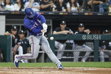 Jun 21, 2023; Chicago, Illinois, USA; Texas Rangers shortstop Ezequiel Duran (20) hits a two-run home run against the Chicago White Sox during the fourth inning at Guaranteed Rate Field. Mandatory Credit: Kamil Krzaczynski-USA TODAY Sports