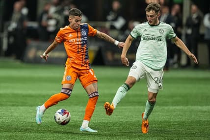 Jun 21, 2023; Atlanta, Georgia, USA; New York City FC midfielder Gabriel Pereira (11) kicks the ball against Atlanta United defender Noah Cobb (24) during the first half at Mercedes-Benz Stadium. Mandatory Credit: Dale Zanine-USA TODAY Sports