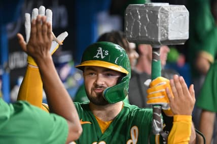 Jun 23, 2023; Toronto, Ontario, CAN;   Oakland Athletics catcher Shea Langeliers (23) celebrates in the dugout with the team home run hammer after hitting a solo home run against the Toronto Blue Jays in the ninth inning at Rogers Centre. Mandatory Credit: Dan Hamilton-USA TODAY Sports